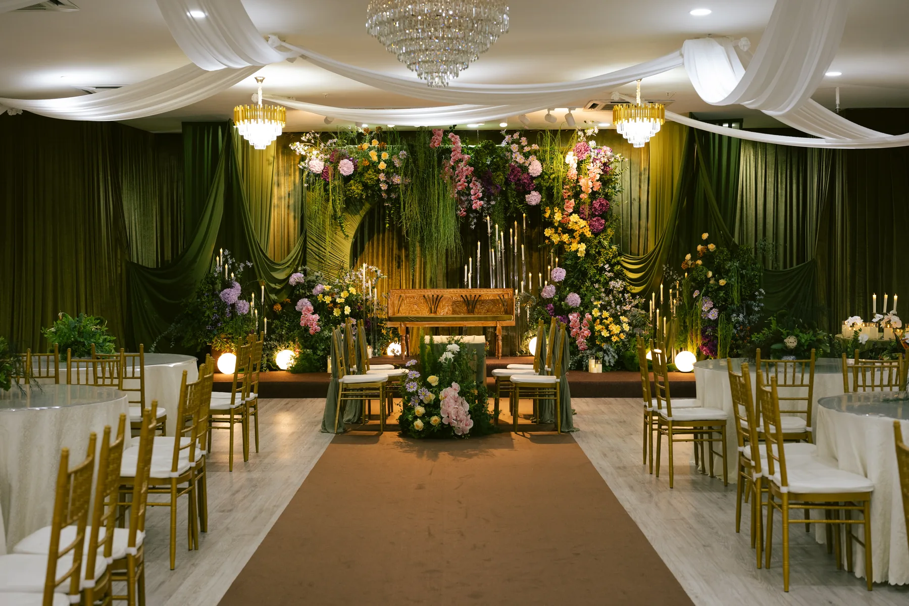 Green floral wedding stage inside Luminare Hall