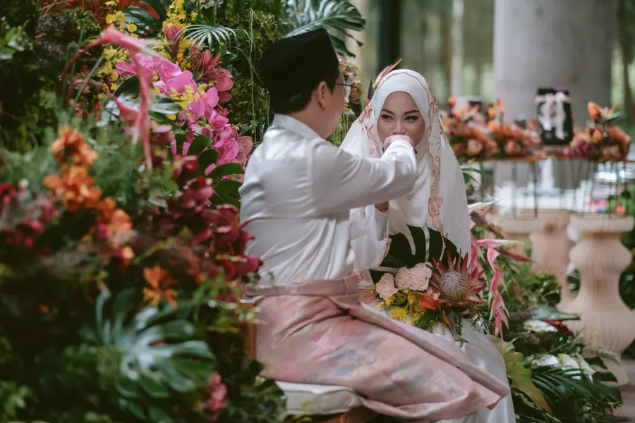 Malay wedding ceremony surrounded by tropical floral styling