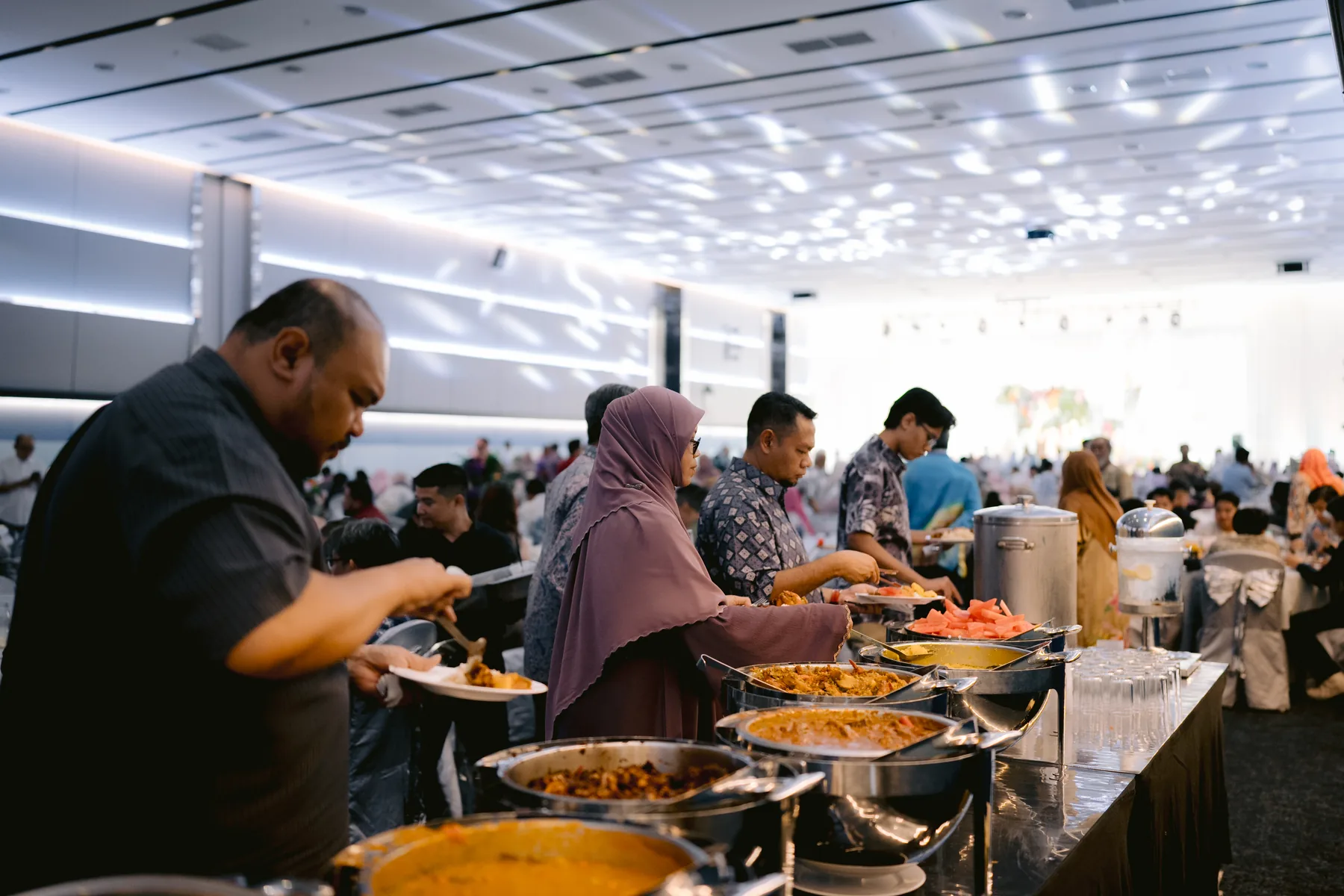 Guests enjoying a catered buffet at a Luminare event